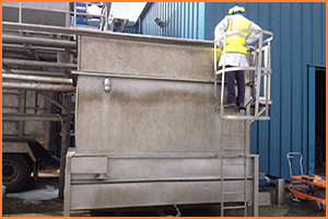 Engineer looking into a vegetable washing tank